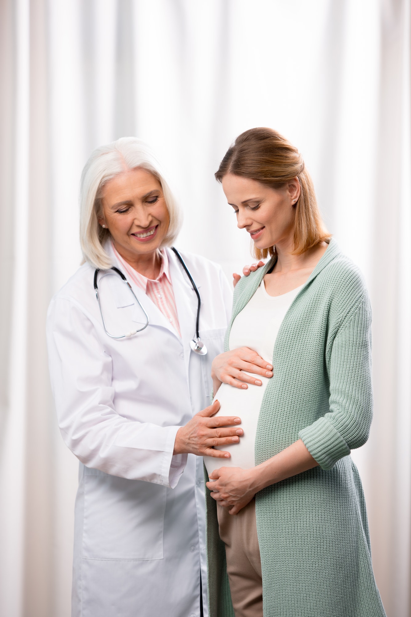 doctor-examining-young-pregnant-woman-during-medical-consultation.jpg